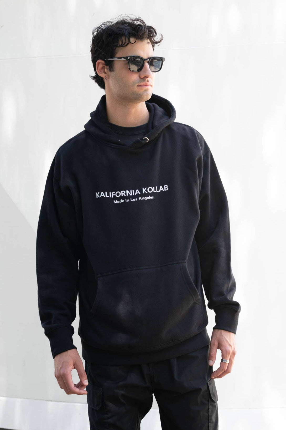 Model wearing soft black Kalifornia Kollab hoodie in Hollywood