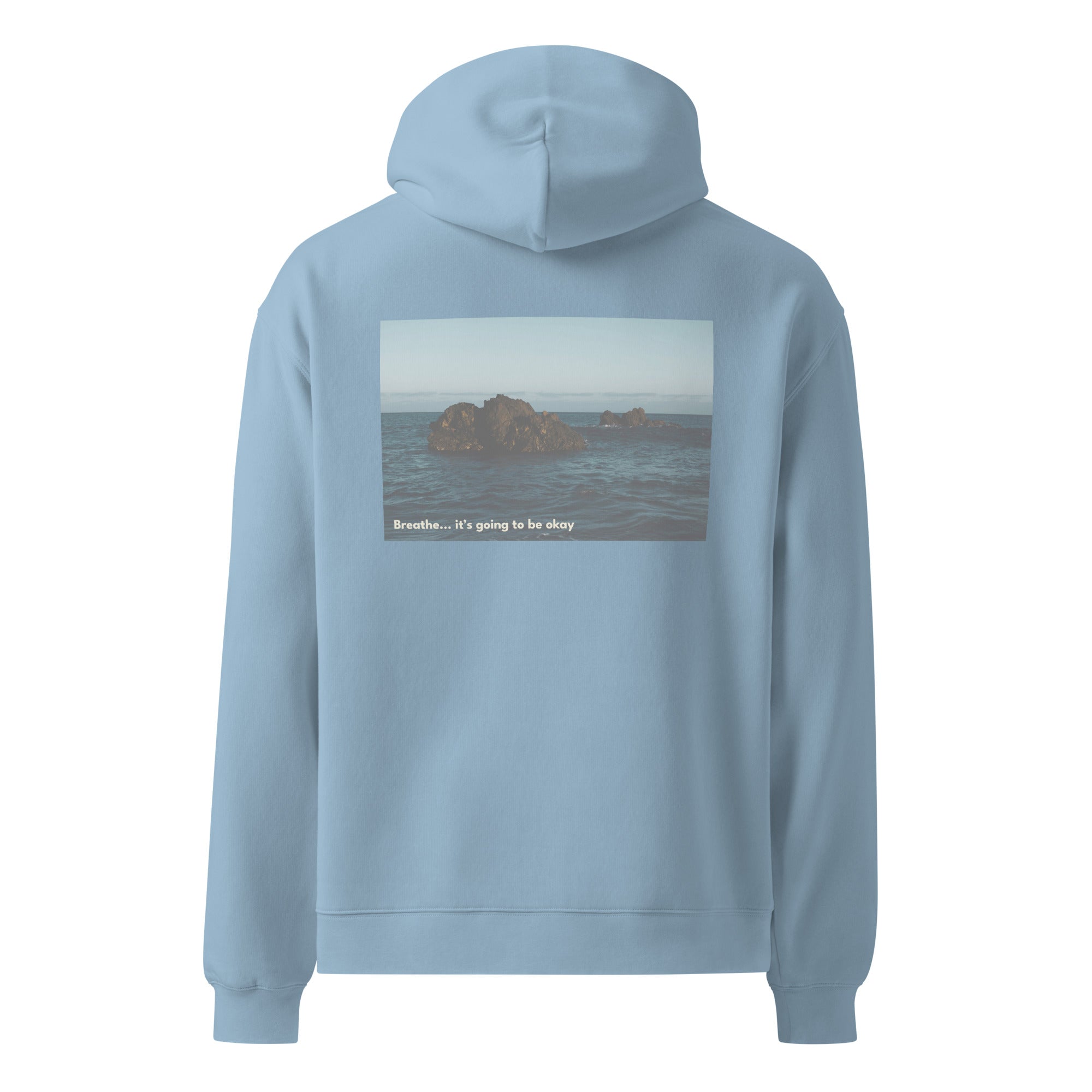 Light blue hoodie with a scenic print on the back against a white background