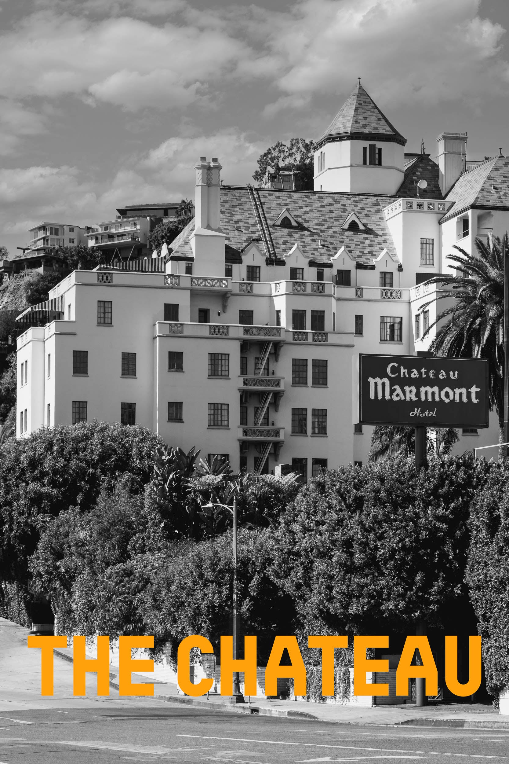 Fine art photograph of the iconic Chateau Marmont hotel in Los Angeles, captured in soft golden hour light with palm trees in the foreground and vintage Hollywood ambiance.